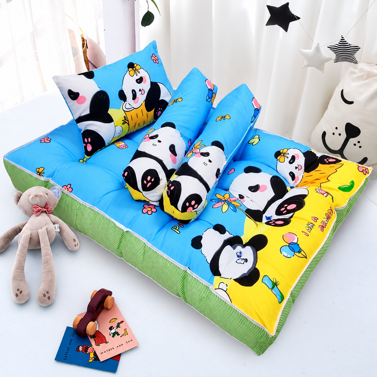 Blue and green baby bedding set with panda-print pillow and bolsters.