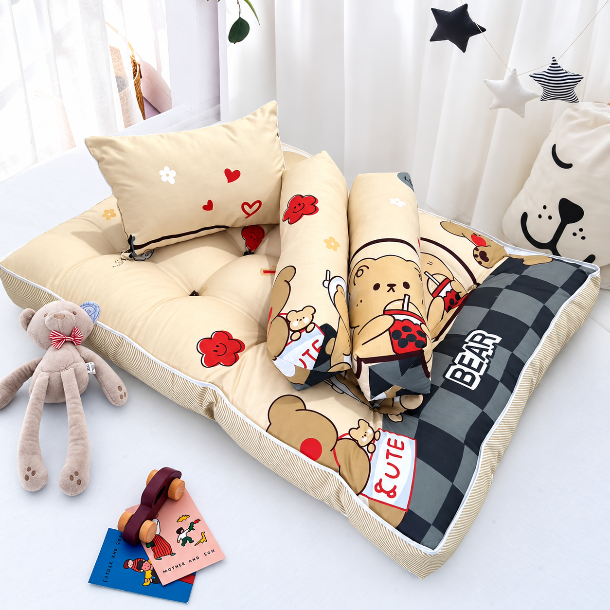Cream and brown bear-print baby mattress with pillows and bolsters.