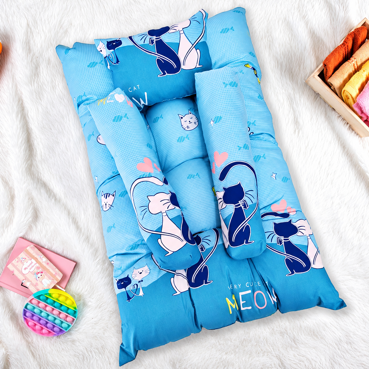 Sky blue baby lounger pillow with cute cartoon cat graphics.